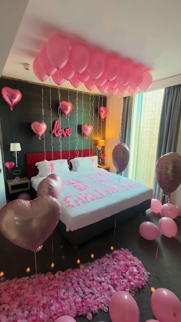 Pink balloons and romantic hotel room decorations
